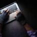 hacker hand stealing data from laptop top down