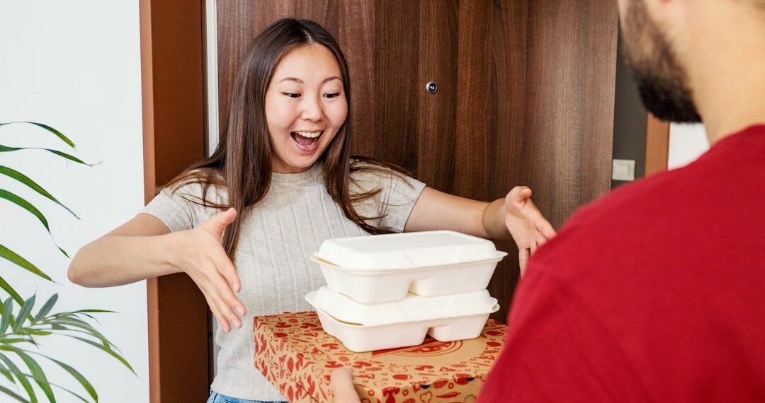 Excited Woman Receiving Food Delivery at Home Door from Courier