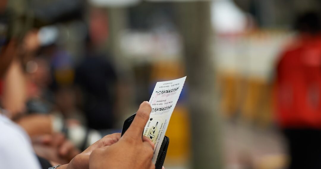 Man holding paper against blurred background