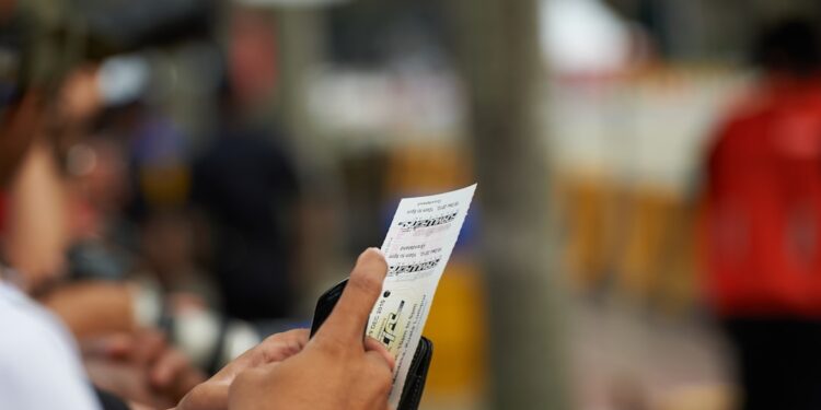 Man holding paper against blurred background