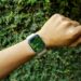 A hand with an Apple Watch about to start an outdoor walk workout, surrounded by nature and natural light.