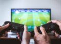 Hands holding the game controllers