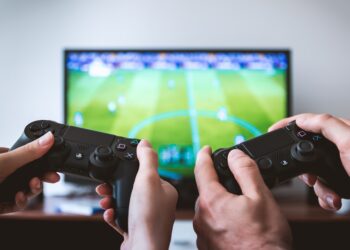 Hands holding the game controllers