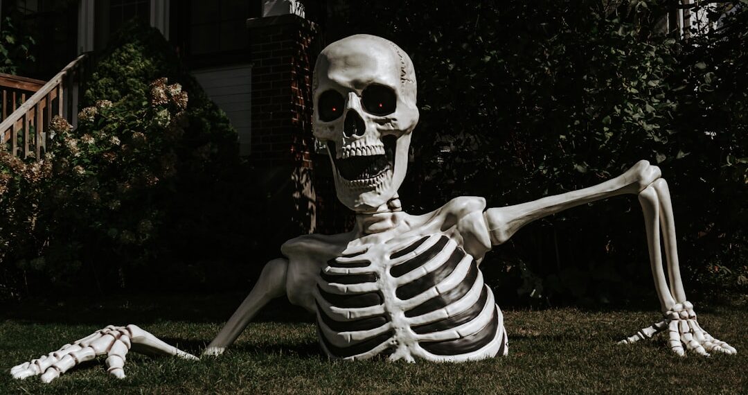 a half-buried Halloween skeleton