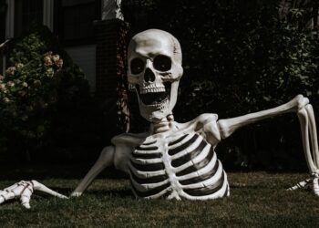 a half-buried Halloween skeleton