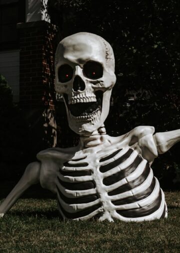 a half-buried Halloween skeleton