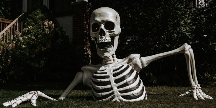 a half-buried Halloween skeleton