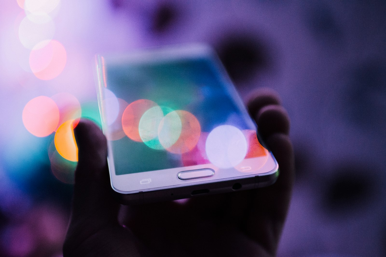 Oudere Android-telefoon in de hand met een berichtenapp op het scherm
