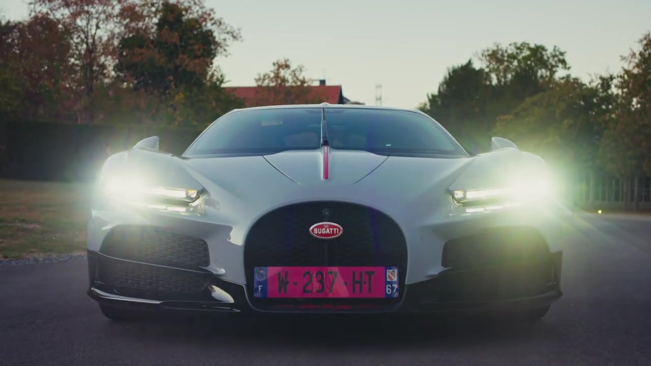 Witte Bugatti Tourbillon met brandende koplampen van voren gezien