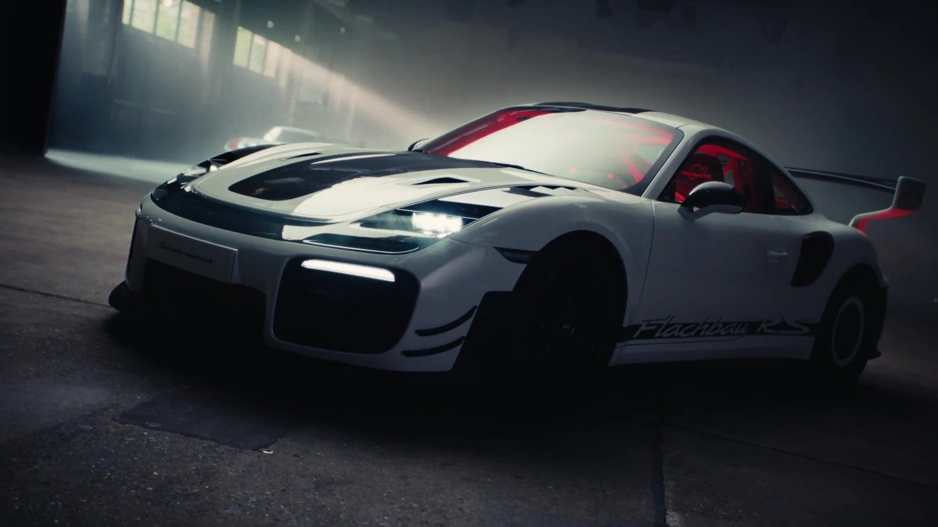 De witte Porsche Flachbau RS met platte neus in een oude fabriekshal